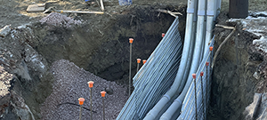 Aerial electrical and telecommunication utilities were relocated underground throughout portions of the south end. Crews installing underground electrical and telecommunication duct bank. This segment crosses the Champlain Parkway and Briggs Street.