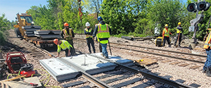 The installation of precast concrete panels for the railroad crossing at Flynn Avenue.