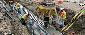 Placement of concrete to encase the electrical and communication duct banks installed at the intersection Lakeside Avenue and the Parkway.