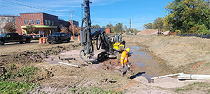 Crews drilling in preparation for blasting to remove ledge along the east side of Briggs Street just south of Flynn Avenue.