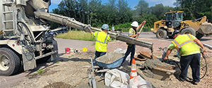 Placing concrete foundations for the traffic signal controller cabinet and the electrical meter pedestal in the northwest corner of the intersection of Flynn Avenue at the Parkway.