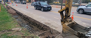 Removing the existing curb and placing subbase materials along the east side of Pine Street in preparation for the installation of new granite curb.