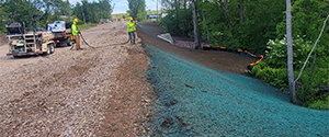 Crews placing hydroseed over the newly installed topsoil around the Englesby Brook box culvert.