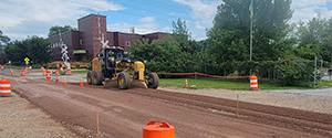 Fine-grading the roadway in preparation for base course paving on Flynn Avenue west of the Flynn Avenue railroad crossing.