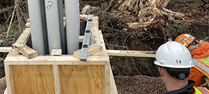 Aerial electrical and telecommunication utilities were relocated underground throughout portions of the south end. Crews installing underground electrical and telecommunication duct bank. This shows the construction of the concrete riser that houses the underground conduits at its terminus on Briggs Street.