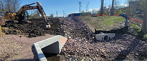 Installation of topsoil around the headwall and wingwalls along the box culvert channeling Englesby Brook and the emergency spillway for the detention pond.