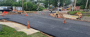 Base course paving at the intersection of Queen City Park Road and Austin Drive.