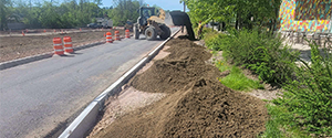 Installation of topsoil behind the newly installed granite curb on Briggs Street.