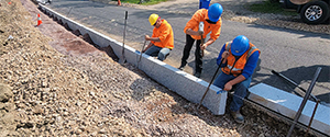 The installation of granite curb along Batchelder Street.